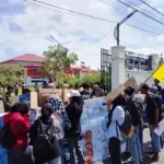 Sejumlah massa aksi dari PMII Cabang Persiapan Pulau Morotai membentangkan spanduk tuntutan di depan Kantor Bupati, Kamis (22/1/2026). Mereka mendesak pemerintah segera menyelesaikan proyek Labkesmas senilai Rp15,3 Miliar dan meratakan bantuan bagi lansia. Sumber foto : Istimewa